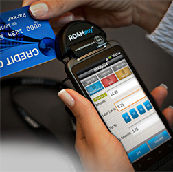 A UMS Funds merchant services client uses one of our mobile credit card processing terminals.